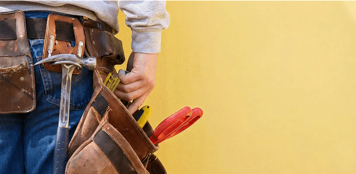 Handyman with tool belt ready for home repairs and maintenance in Bakersfield, CA